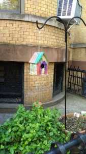 photo of a colorful wooden bird house