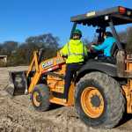 Figure 4: LSJA Participant teaching college staff how to drive a backhoe